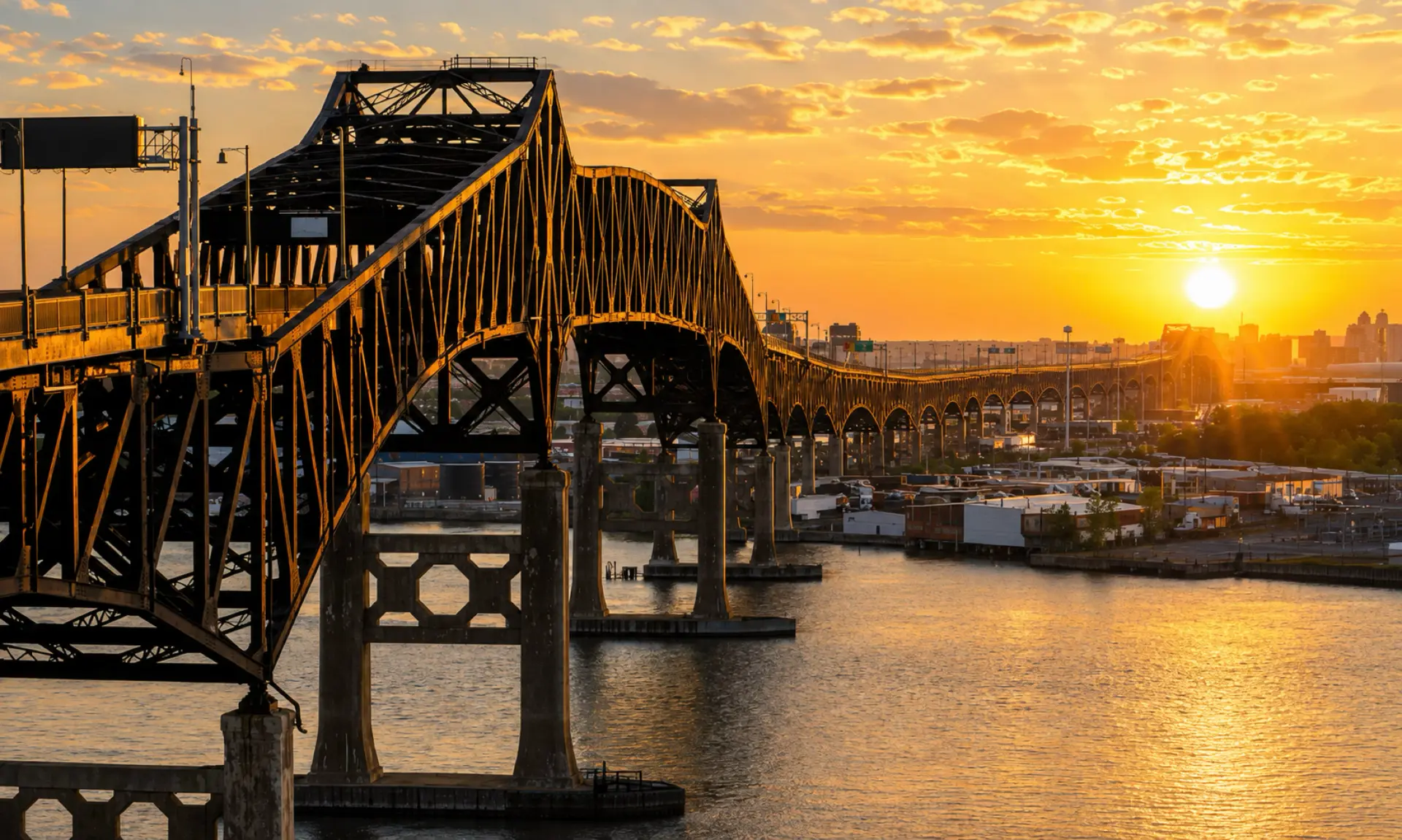 Steel truss bridge over New Jersey water at sunset